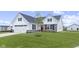A charming home with a well-kept lawn, a stone accent facade, and a lovely, landscaped yard at 1202 Brightwood Cir, Greenfield, IN 46140