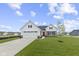 Beautiful exterior of a home featuring a white facade, stone accents, well-manicured lawn, and a two-car garage at 1202 Brightwood Cir, Greenfield, IN 46140