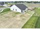 New home featuring white siding, a dark roof, and a spacious green yard at 1202 Brightwood Cir, Greenfield, IN 46140