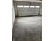 Clean garage interior featuring a white garage door with windows and concrete floor at 1202 Brightwood Cir, Greenfield, IN 46140