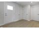 Hallway showing modern flooring with white doors and trim, enhancing a bright and functional design at 1202 Brightwood Cir, Greenfield, IN 46140