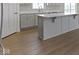 Modern kitchen with a center island, white countertops, shaker cabinets, and contemporary flooring at 1202 Brightwood Cir, Greenfield, IN 46140