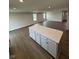 Large kitchen island with a white countertop and ample cabinet storage in an open layout space at 1202 Brightwood Cir, Greenfield, IN 46140
