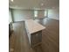 Modern kitchen island featuring a stone countertop and ample storage in the open kitchen and living area at 1202 Brightwood Cir, Greenfield, IN 46140
