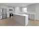 Well-equipped kitchen with stainless steel appliances, white cabinets, and a large center island for cooking and entertaining at 1202 Brightwood Cir, Greenfield, IN 46140