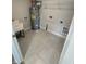 Practical laundry room features a utility sink, water heater, and washer/dryer hookups at 1202 Brightwood Cir, Greenfield, IN 46140