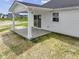 A covered patio features white columns, a concrete floor, and a sliding glass door for easy access at 1202 Brightwood Cir, Greenfield, IN 46140