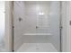 Modern shower with light tile, glass enclosure, built-in bench, and elegant fixtures at 1202 Brightwood Cir, Greenfield, IN 46140