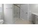 Bright bathroom with a tiled shower, featuring a glass door, built-in bench, and neutral color palette at 1202 Brightwood Cir, Greenfield, IN 46140