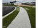 New concrete sidewalk winding through a community with newly seeded lawns at 1202 Brightwood Cir, Greenfield, IN 46140