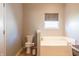 Relaxing bathroom with a soaking tub, toilet, and window with a view at 14461 Brook Meadow Dr, McCordsville, IN 46055