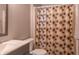 A half bathroom features decorative shower curtain, a toilet, and a modern sink with a cabinet at 14461 Brook Meadow Dr, McCordsville, IN 46055