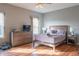 Spacious bedroom with hardwood floors, natural light from two windows, and a comfortable bed at 14461 Brook Meadow Dr, McCordsville, IN 46055