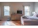 Sunlit bedroom featuring hardwood floors, natural light from two windows, and a dresser at 14461 Brook Meadow Dr, McCordsville, IN 46055