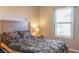 Comfortable bedroom features a large bed, a nightstand, and a bright window that fills the room with light at 14461 Brook Meadow Dr, McCordsville, IN 46055