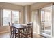 Cozy dining room with a table with six chairs, large window, and sliding glass doors at 14461 Brook Meadow Dr, McCordsville, IN 46055