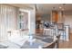 Open dining area with a table with six chairs, a sliding glass door, and a view of the kitchen at 14461 Brook Meadow Dr, McCordsville, IN 46055