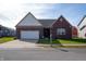 Charming brick home with a well-manicured lawn and attached two-car garage at 14461 Brook Meadow Dr, McCordsville, IN 46055