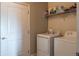 Functional laundry room includes modern washer and dryer units and storage shelving at 14461 Brook Meadow Dr, McCordsville, IN 46055