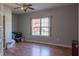 Cozy living room features hardwood floors, a ceiling fan, and a bright window with natural light at 14461 Brook Meadow Dr, McCordsville, IN 46055