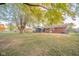 Expansive backyard featuring a screened-in porch, mature trees and a well-maintained lawn at 1718 Charles St, Anderson, IN 46013