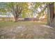 Large backyard featuring a firepit and mature trees, perfect for outdoor gatherings at 1718 Charles St, Anderson, IN 46013