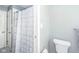 Cozy bathroom featuring blue-striped shower curtain and neutral walls, with a toilet visible at 1718 Charles St, Anderson, IN 46013