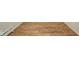 Close up view of wood-look laminate flooring in a room with white trim and a radiator at 1718 Charles St, Anderson, IN 46013