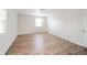 Clean, bright bedroom featuring wood-look floors and a window for ample natural light at 1718 Charles St, Anderson, IN 46013