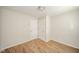 Bright bedroom featuring a window, two white doors, light-colored walls, and wood-look laminate flooring at 1718 Charles St, Anderson, IN 46013