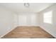 Open bedroom featuring wood-look flooring, double closets, and bright natural light from the window at 1718 Charles St, Anderson, IN 46013