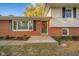 Charming brick home featuring a decorative fall wreath on the front door and manicured landscaping at 1718 Charles St, Anderson, IN 46013