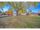 Well-maintained front lawn with large trees highlighting this charming two-story home at 1718 Charles St, Anderson, IN 46013