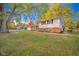Charming home with a well-maintained front yard and mature trees at 1718 Charles St, Anderson, IN 46013