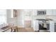 Modern kitchen boasts stainless steel microwave and gas range, white subway tile backsplash, and wood floors at 1718 Charles St, Anderson, IN 46013