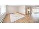 Bright living room with wood floors, light walls, and a decorative area rug at 1718 Charles St, Anderson, IN 46013