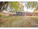 Spacious yard with partial view of the back of the brick and siding home with a screened in porch at 1718 Charles St, Anderson, IN 46013
