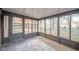 Cozy sunroom with backyard views through large windows, offering bright natural light and a rug at 1718 Charles St, Anderson, IN 46013