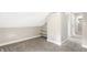 Finished attic space featuring carpeted floors, shelving, and a doorway to another room at 1933 Koehne St, Indianapolis, IN 46202