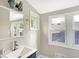 Bright bathroom with a modern sink, vanity, and multiple windows offering natural light at 1933 Koehne St, Indianapolis, IN 46202