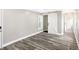 Large bedroom with vinyl flooring, neutral colors, window, and barn door closet at 1933 Koehne St, Indianapolis, IN 46202