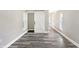 Spacious bedroom with new gray vinyl flooring, white trim, and a modern barn door at 1933 Koehne St, Indianapolis, IN 46202