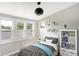 Well-lit bedroom with shelves, toys, and large windows offering plentiful sunlight at 1933 Koehne St, Indianapolis, IN 46202