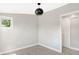 Empty bedroom featuring a geometrically designed black light fixture and a sliding barn door closet at 1933 Koehne St, Indianapolis, IN 46202