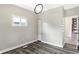 Bedroom with modern light fixture, neutral walls, vinyl flooring, and natural light from the window at 1933 Koehne St, Indianapolis, IN 46202