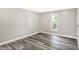 Bright bedroom features new gray vinyl flooring, white trim, and a window at 1933 Koehne St, Indianapolis, IN 46202