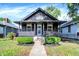 Charming home featuring a covered front porch, stone exterior, and well-maintained landscaping at 1933 Koehne St, Indianapolis, IN 46202
