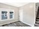 Hallway with new gray vinyl flooring, white trim, and two windows at 1933 Koehne St, Indianapolis, IN 46202
