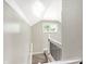 Upstairs hallway with a small window and white trim at 1933 Koehne St, Indianapolis, IN 46202