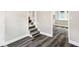 Hallway with new gray vinyl flooring and carpeted stairs leading to the upper level at 1933 Koehne St, Indianapolis, IN 46202
